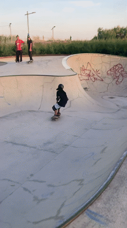 Skaters and BMX riders session a Barcelona bowl at sunset