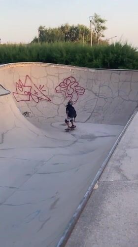Skaters and BMX riders session a Barcelona bowl at sunset
