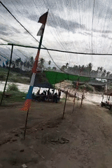 Dirt paths and a pink bridge in rural Kapa, Indonesia