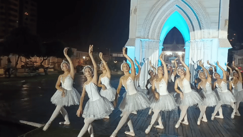 Ballet dancers perform nighttime show at illuminated Iquique landmarks