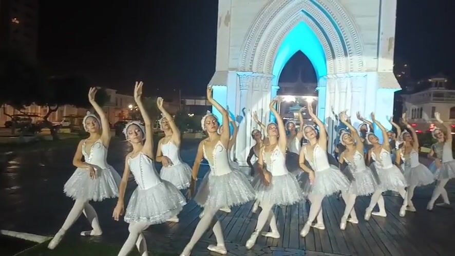 Ballet dancers perform nighttime show at illuminated Iquique landmarks