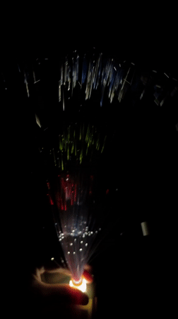 Person holds colorful fiber optic lamp in Dhaka