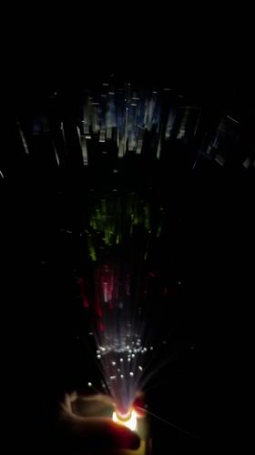 Person holds colorful fiber optic lamp in Dhaka