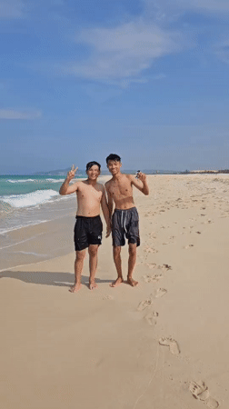 Young men enjoy morning beach time in Vietnam
