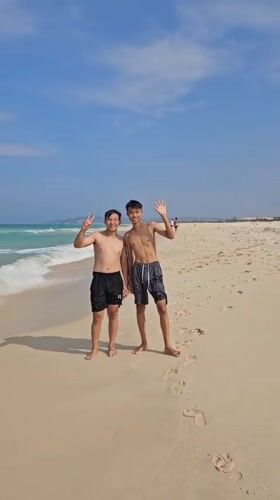 Young men enjoy morning beach time in Vietnam