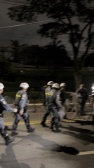 Riot police deploy with shields, barriers on São Paulo street
