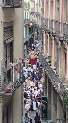 Street procession and market bustle in central Barcelona