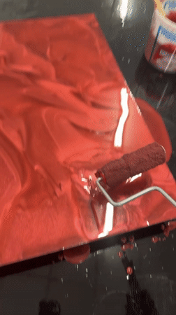 Metallic red liquid rolled across a dark surface in El Paso