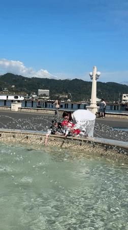 Three people gather at fountain in Sokhumi, Abkhazia