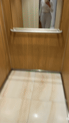 Woman spotted in wood-paneled elevator in Budva, Montenegro