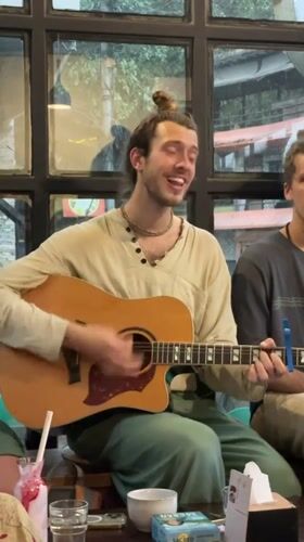 Acoustic guitarist performs informal session at Pokhara cafe