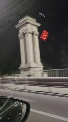 Nighttime drive through Varna streets, dashboard and mirror in view.