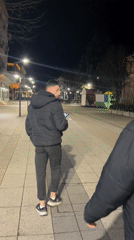 Young men socialize on decorated evening streets in Vratsa