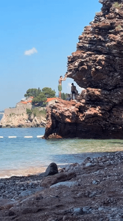 Paddleboarding and cliff views on a calm Montenegrin morning