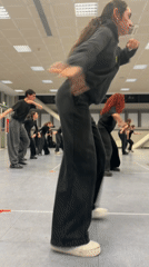 Dance group practices movement exercises in Bologna studio