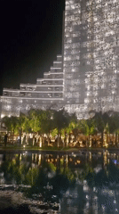Evening social gathering at illuminated tropical resort complex