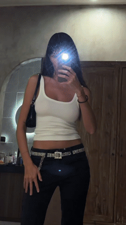 Woman documents outfit through mirror selfies in North Kuta