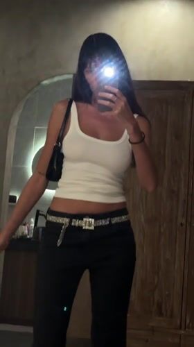 Woman documents outfit through mirror selfies in North Kuta