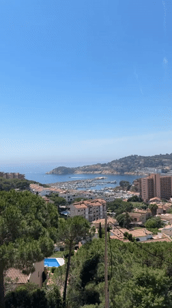 Tourist documents harbor visit in Sant Feliu de Guíxols
