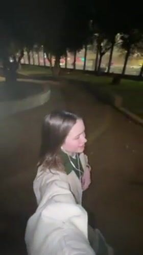Woman walks through Tel Aviv park at night