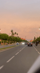 Evening drive through Marrakesh streets captures sunset urban scenes