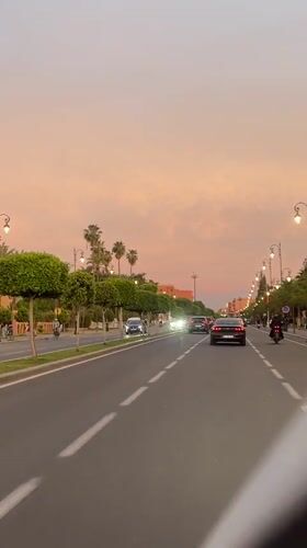 Evening drive through Marrakesh streets captures sunset urban scenes