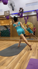 Woman practices yoga routine in mirrored Nha Trang studio