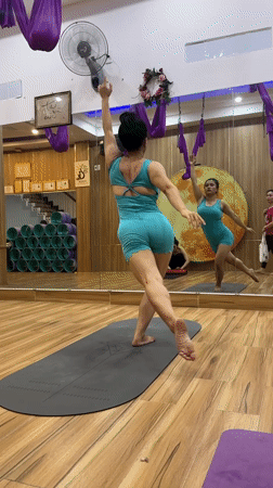 Woman practices yoga routine in mirrored Nha Trang studio