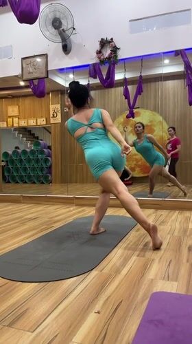 Woman practices yoga routine in mirrored Nha Trang studio