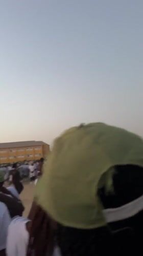 Young adults in uniform gather for outdoor activity in Maiduguri