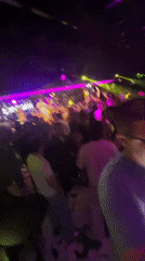 Nightclub crowd dances under colorful lights in Sofia