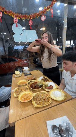 Diners photograph food at Davao City restaurant