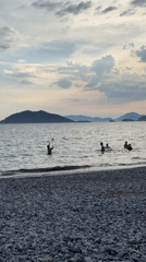 Families enjoy afternoon beach activities in Fethiye, Turkey
