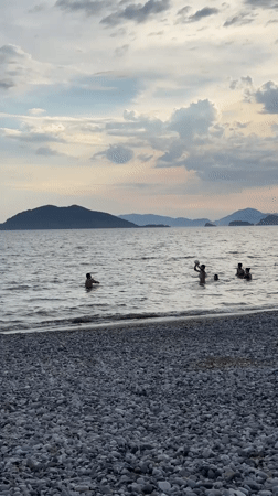 Families enjoy afternoon beach activities in Fethiye, Turkey