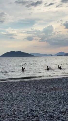 Families enjoy afternoon beach activities in Fethiye, Turkey