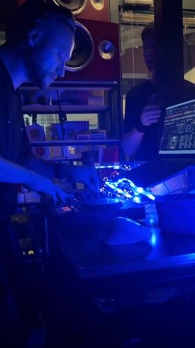 Late-night DJ set at a Budva venue with Ferris wheel backdrop