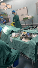 Operating room prepared for surgery with instruments and draping