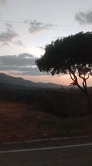 Sunset displays vibrant colors over mountainous landscape
