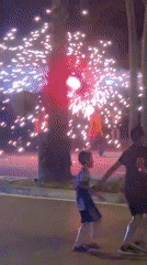 Nighttime fireworks celebration on Barcelona street with police presence