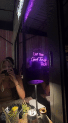 Late-night dining captured at Miami restaurant with neon signage