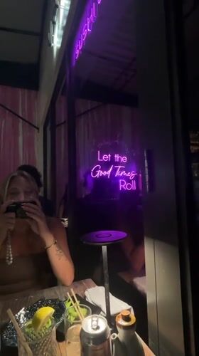 Late-night dining captured at Miami restaurant with neon signage