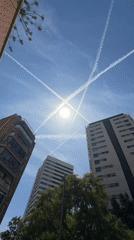 Aircraft contrails form X-pattern over Spanish skies