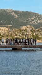 Tourist Group Gathers on Budva Pier During Afternoon