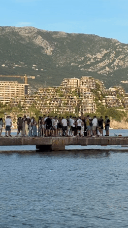 Tourist Group Gathers on Budva Pier During Afternoon