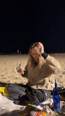 Evening beach gathering observed in Tel Aviv with drinks and snacks