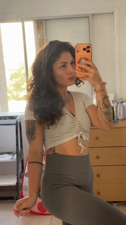 Woman takes mirror selfies in Kiryat Bialik home