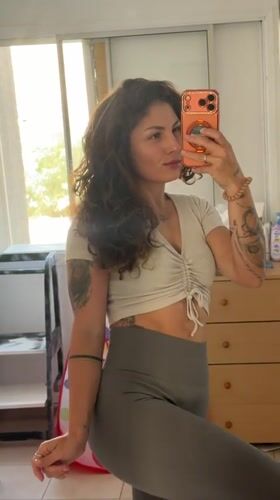 Woman takes mirror selfies in Kiryat Bialik home