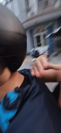 Couple rides scooter through Đà Nẵng, woman takes helmet selfies