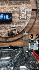 Man takes tea selfie in Bulgarian barbershop mirror