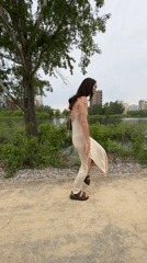 Woman strolls riverside park path in Tyumen, Russia